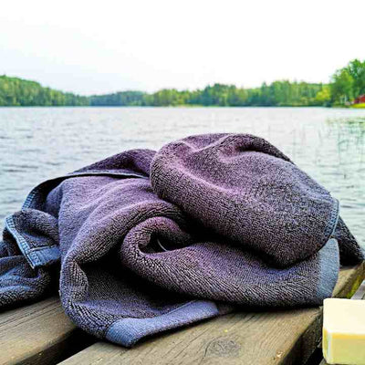 Black bamboo bath towel by lake